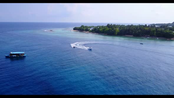 Aerial scenery of luxury lagoon beach journey by blue ocean with white sand background of a dayout n