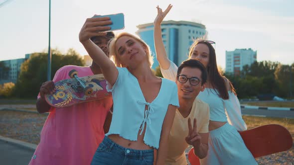 Young Multiethnic Hipster Friends on Summer Holidays Make Selfie Using Smartphone at Beach