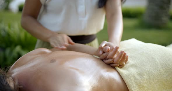 Professional Masseur Massages Customer Back at Yellow Towel