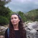 Lady poses looking into camera against mountain river rocks - VideoHive Item for Sale