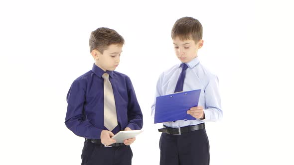 Two Young Businessmen Boys Stipulate Reports and Graphs. White Studio