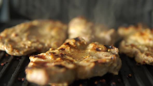 Grilled pork steak slices. juicy beef steak cooked on the grill. slow motion
