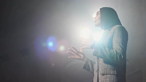 The Female Financial Coach Emotional Gesturing Talks From the Stage with Spectators at Forum. Too