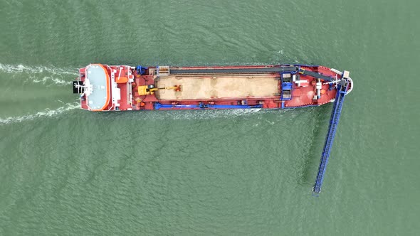 Bird's Eye View of a Self Unloading Barge Carrying Cargo At Sea