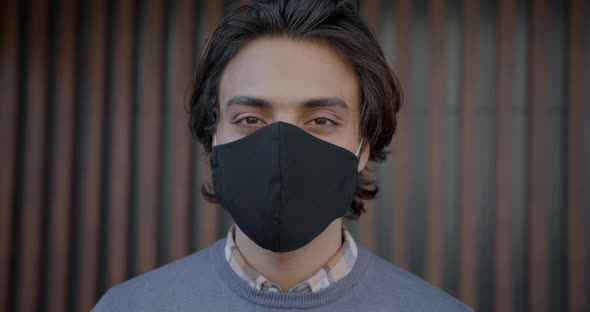 Closeup Portrait of Middle Eastern Man Wearing Multipleuse Face Mask Outdoors