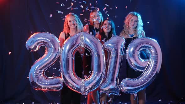 Group of Young Women Are Having Fun and Holding Bigger Numbers 2019