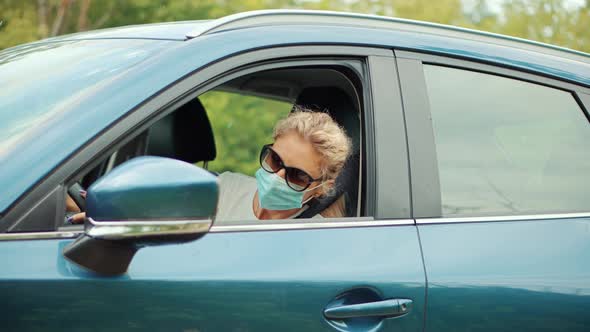 Driver Protective Face Mask In Car. Businessman In Sunglasses Drive Vehicle. Self Isolation On Car.