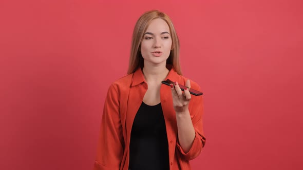 Close Up of a Woman That Recording a Vocal Massage on Her Smartphone