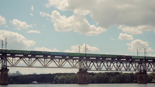 Cargo Train Moving On Railroad Bridge. Kiev City Bridge. Freight Train Passing Railroad Delivery.
