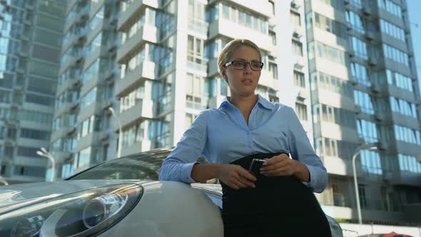 Woman Crying Near Automobile, Financial Difficulties, Inability to Pay Car Loan