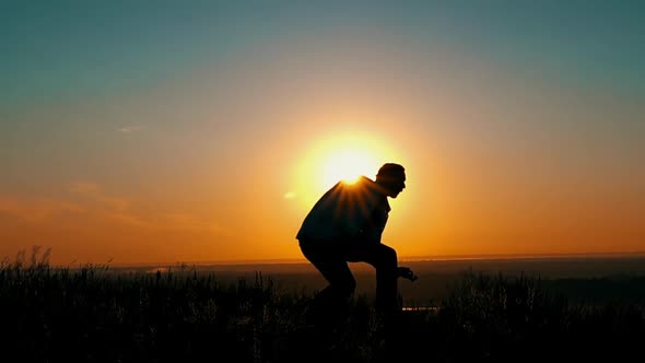 Man Have Fun Playing Guitar at Sunrise