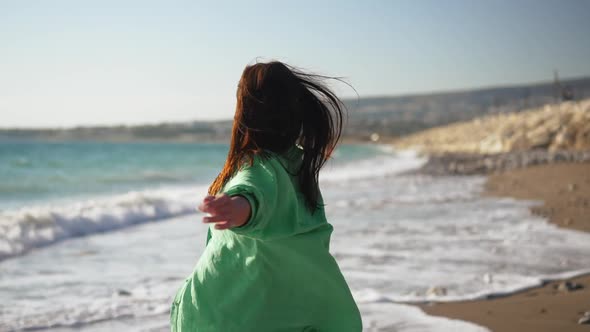 Young Slim Beautiful Caucasian Woman Spinning Strolling on Picturesque Mediterranean Sea Beach with