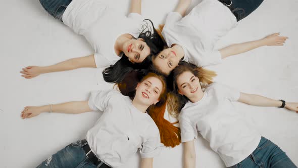 Group of Teenage Friends on a White Background Are Looking at the Camera and Smiling. Studio Footage