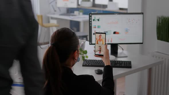 Executive Business Woman Wearing Protective Face Mask Using Phone for Online Videocall Conference