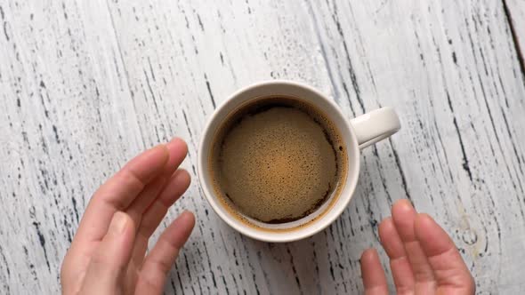 Female Hands Takes a Cup of Coffee. Woman Warms Her Hands with Hot Coffee Cup. FHD, 