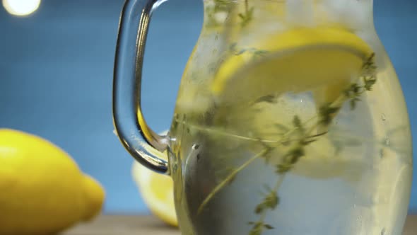 Stirring lemonade with thyme