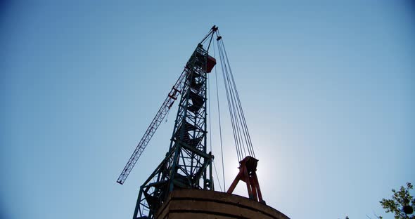 Crane Rotate at Building Construction Site, Architecture Apartments. Wide Shot 