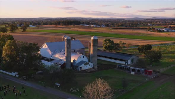 Fantastic 360 shot of farmhouse and grain silos during a beautiful autumn sunset