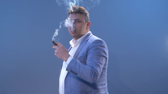 Businessman smoking cigar.