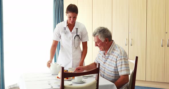 Nurse offering a cake to his patient 4k