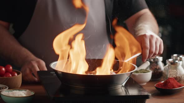 Chef Frying Ribs with Flambe Technique