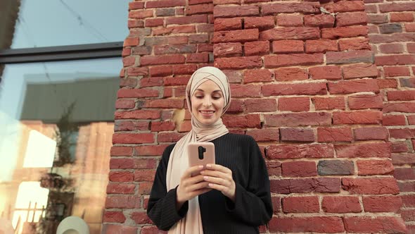 Beautiful Young Woman with Hijab Working Using Smartphone During Break