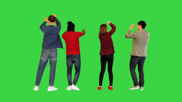 Multiethnic Group of Young Friends Dancing on a Green Screen Chroma Key