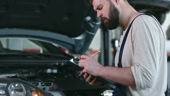 Mechanic Checking Car Engine