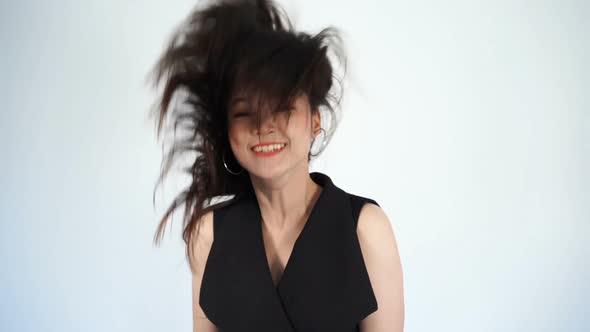 slow-motion of young woman flicking her hair
