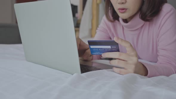 Young woman entering payment information form plastic card in cellphone application,Shopping Online.