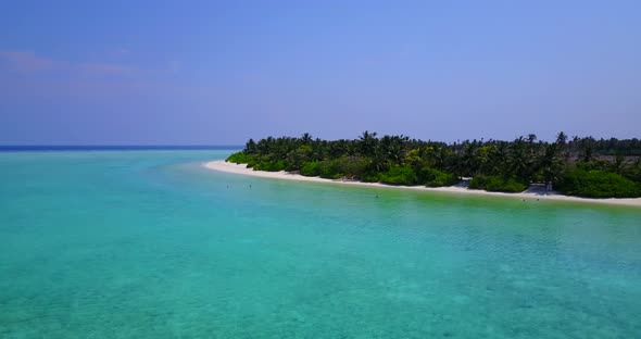 Wide angle above clean view of a white paradise beach and blue sea background 