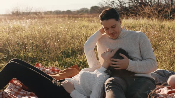 Couple Relax On A Field