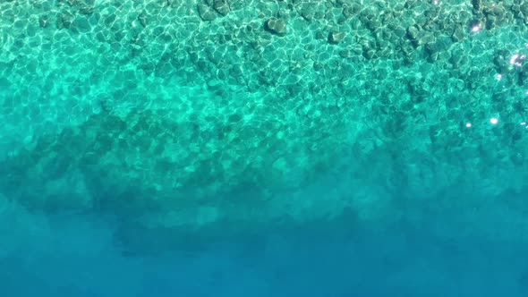Waves and azure water as a background. View from drone at the ocean surface.