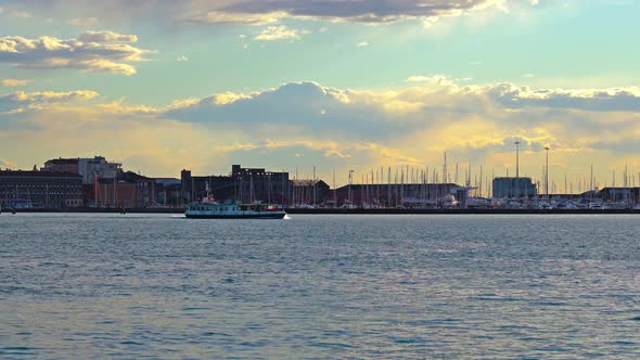 Large City Waterfront with Boat Sailing on Venetian Lagoon