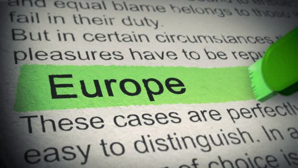 Europe. Highlighter pen marks word in Newspaper. Closeup. Thumbing pages and promoting text with mar