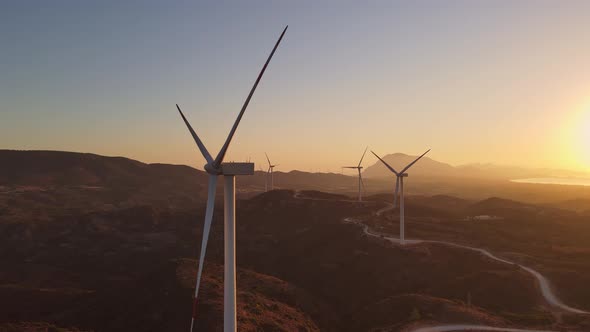 Windmills Farm for Power Production on Beautiful Landscape at Sunrise