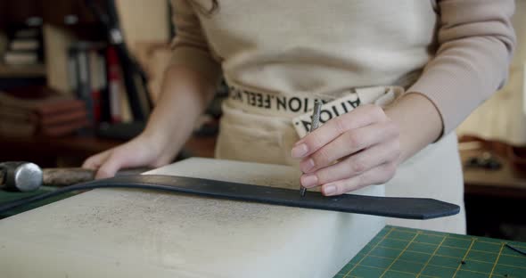 Close Up Shot of Specialist Working with Leather Female Hands of a Craftswoman Make Holes in a