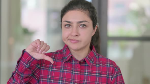 Portrait of Thumbs Down Gesture By Indian Woman