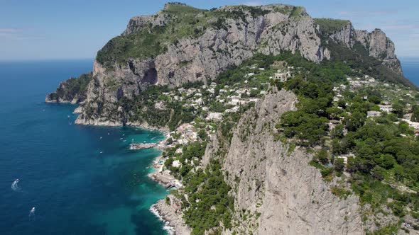 Rugged and precipitous terrain of touristy Capri island, Italy; aerial arc