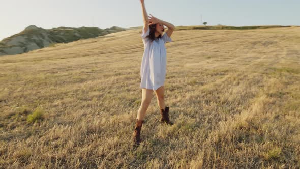 Italian Girl Dances in a Wheat Field in the Countryside