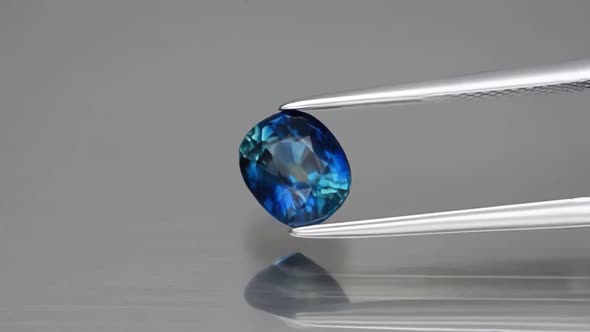 Natural Blue Sapphire Gem on the Background