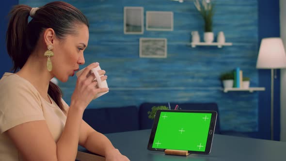 Freelancer Holding Touchpad with Mock Up Green Screen