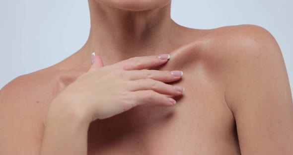 Closeup Beauty Portrait of Young Woman with Smooth and Healthy Skin Strokes Her Skin at Collarbone