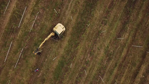 Excavator Hammers a Concrete Pillar