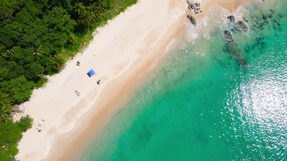 Aerial view shot. Drone camera over white beach sand and sew water clear. Nature video view of beaut