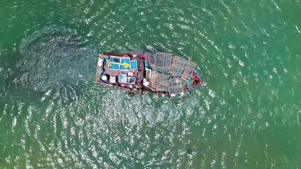 Aerial view of fishing boat navigating on transparent river, Cascalve, Brazil.
