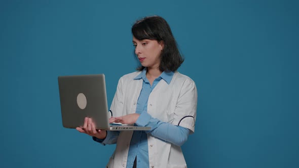 Microbiology Chemist Doing Research Work on Laptop in Studio alt