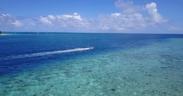 Luxury fly over travel shot of a summer white paradise sand beach and aqua turquoise water backgroun