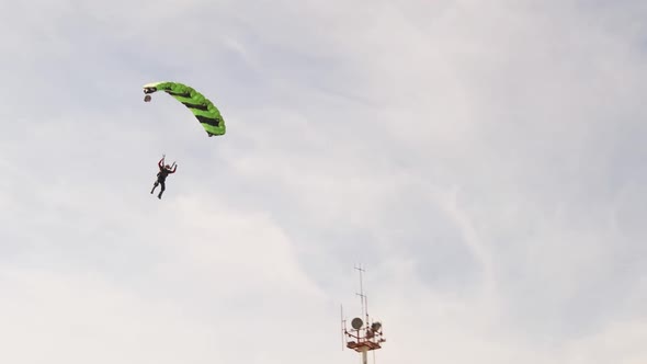 The Parachutist Flying and Lands on the Ground in the Field Extreme Sport