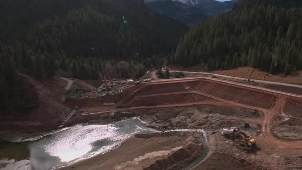 Aerial view flying over construction worksite at lake